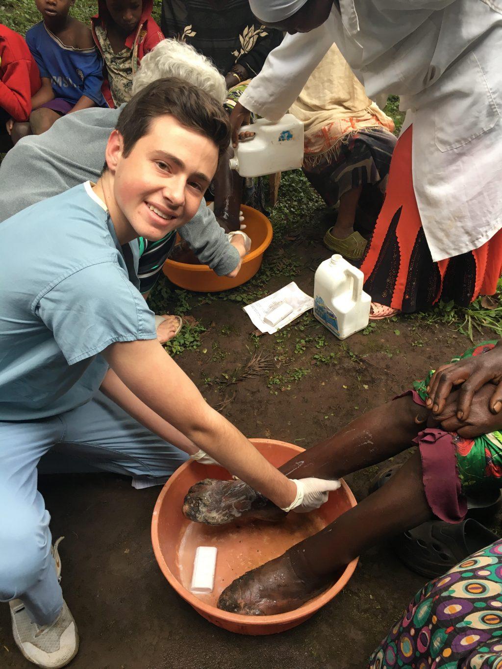 Ishak washes the feet of a child in Ethiopia. He said the experience was very humbling.