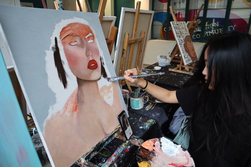 Keung paints an original portrait. During the summer, Keung and her friends painted and traveled throughout Hong Kong.