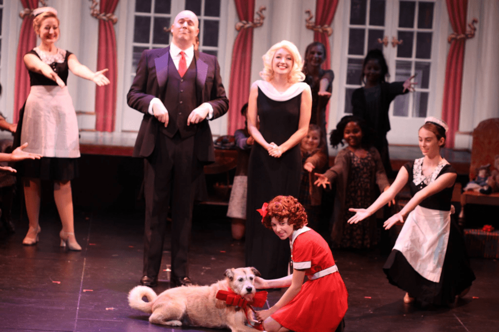 Condolon (bottom right) performs in her first off-broadway show, "Annie Warbucks" — a sequel to the broadway show "Annie." She embodied the role of Annette the maid during her sophomore year of high school.