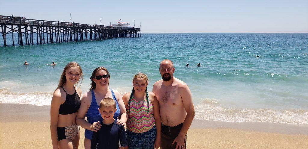 Douville (far left) and her family soak up the sun in Newport Beach, Calif., during a trip in August 2018. She said she was drawn to Pepperdine's location and Christian environment.