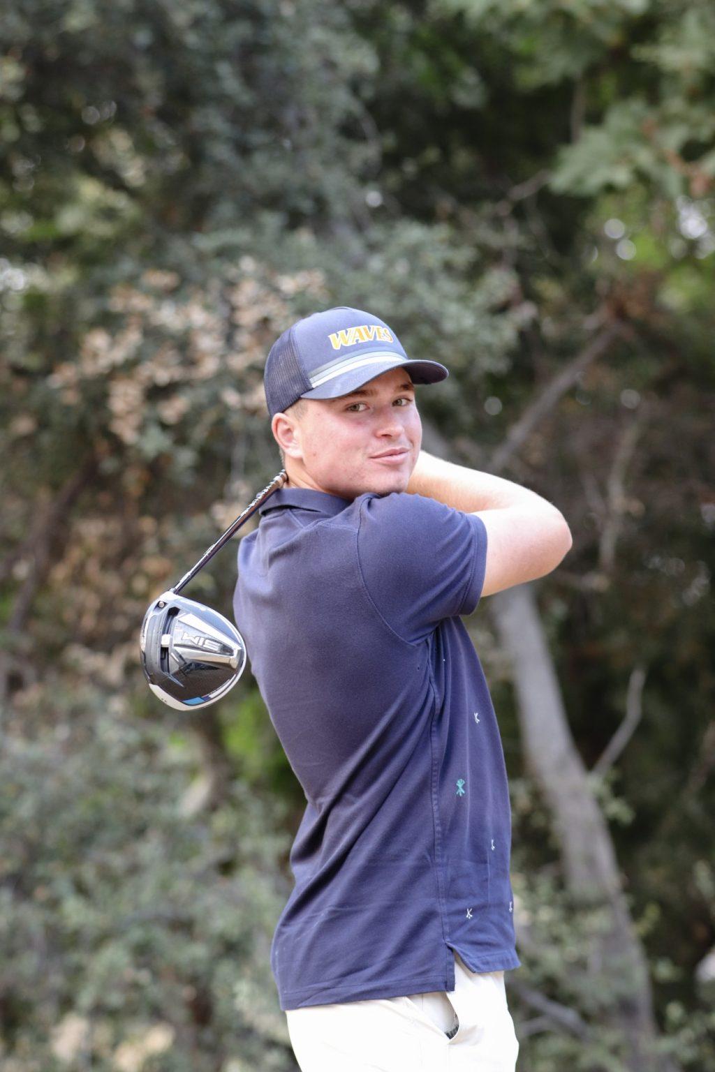 Freshman Caden Fioroni poses with his driver. The lone freshman on the 2020–2021 Pepperdine Men's Golf team said he uses his natural driving and long iron talent on long courses so he can let his natural talent of driving shine. Photo by Ali Levens