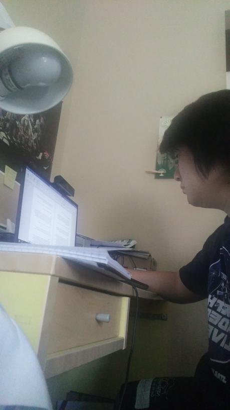 Law student Philip Hong completes classwork with his laptop and notebook. Hong said making a conscious effort to speak to people creates a sense of community and keeps him in touch with his distanced friends. Photo courtesy of Philip Hong