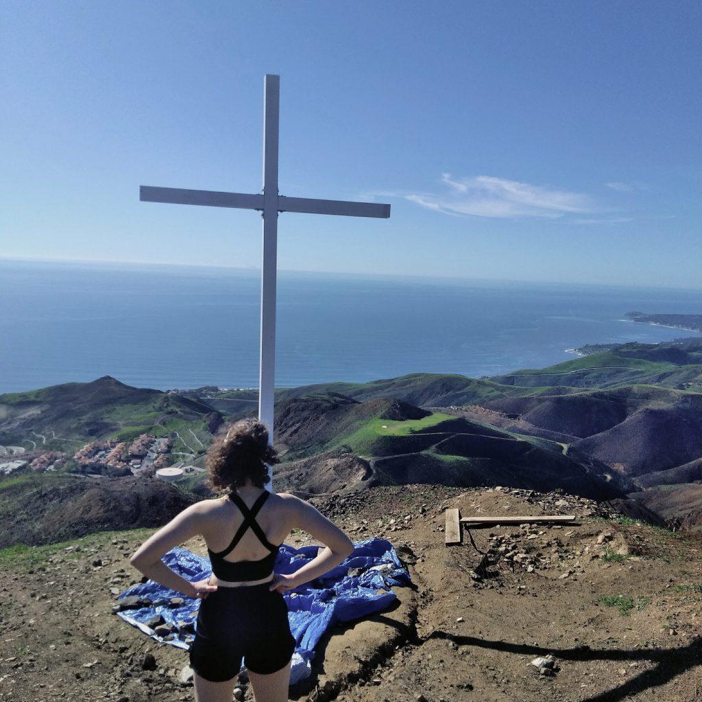 Nature-loving junior Angelea Hayes reaches the end of her hike to the cross, sat atop the Pepperdine Malibu campus. Hayes said nature is her happy place and plans to hike this trail many times before she graduates. Photo courtesy of Angelea Hayes