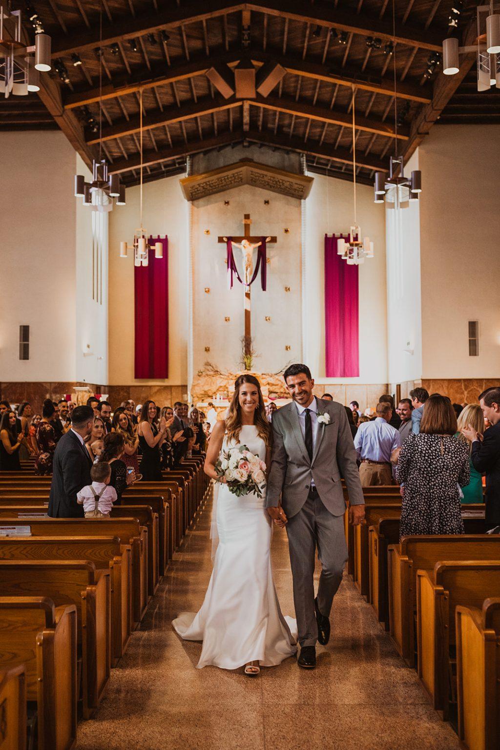 Larsen and her AVP tour pro husband, Bill Kolinske, walk down the aisle at their wedding this year. The two pro players got engaged at center court during a tournament in 2019. Photo courtesy of Kelley Larsen