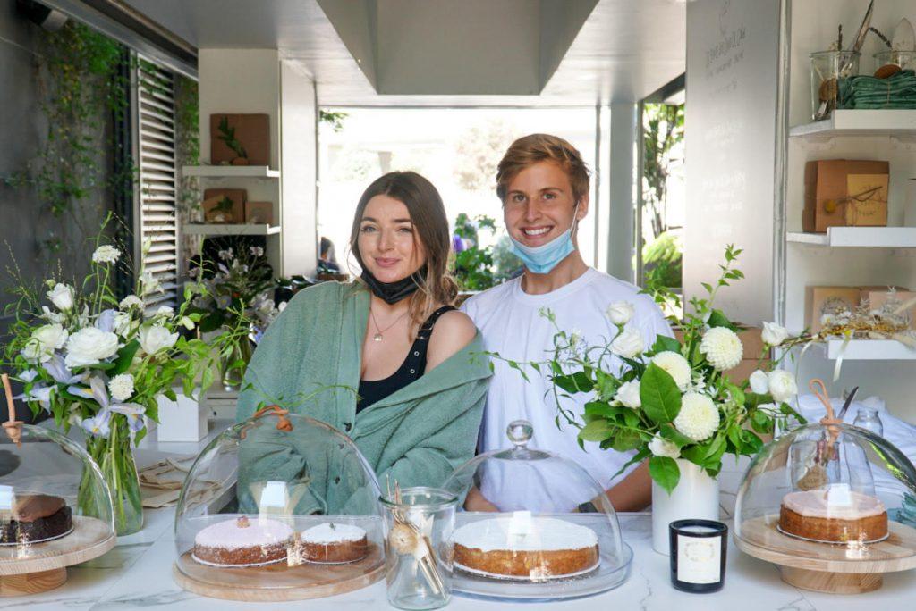 Johnson and coworker Ashling Sugarman stand behind a plethora of baked goods at the Little House Confections pop-up shop. They have displayed their specialty cake, the Bomb Ass Olive Oil Cake, which has gone Internet famous. Photo courtesy of Chase Johnson