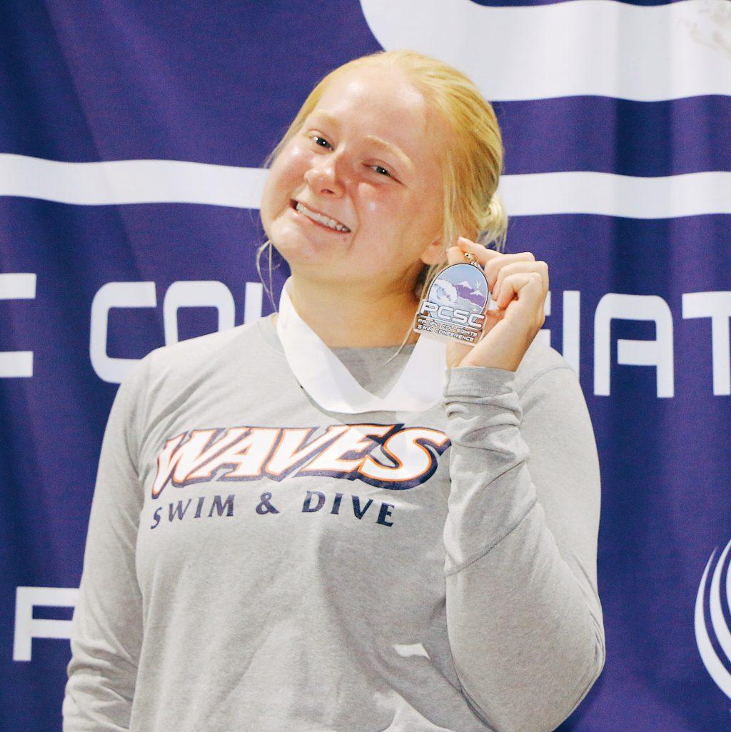 Junior Paulina Holmberg stands with her third-place medal from the Pacific Collegiate Swim and Dive Conference Championships for the 1-meter springboard in February 2020. Holmberg advised sticking to a schedule when looking to solidify a fitness routine. Photo courtesy of Paulina Holmberg