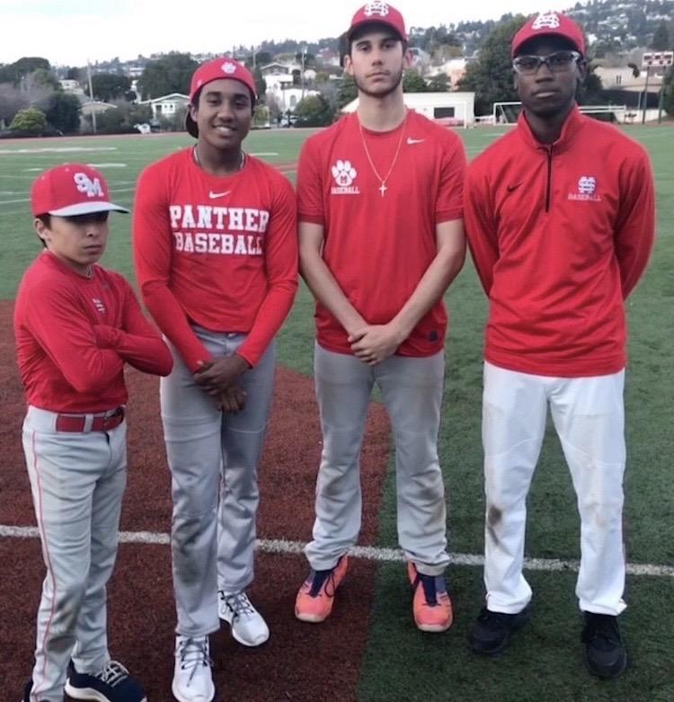 Miles (second from the left) stands on the field for his last time in March while mentoring children with his baseball team. Due to COVID-19, his baseball season was canceled.