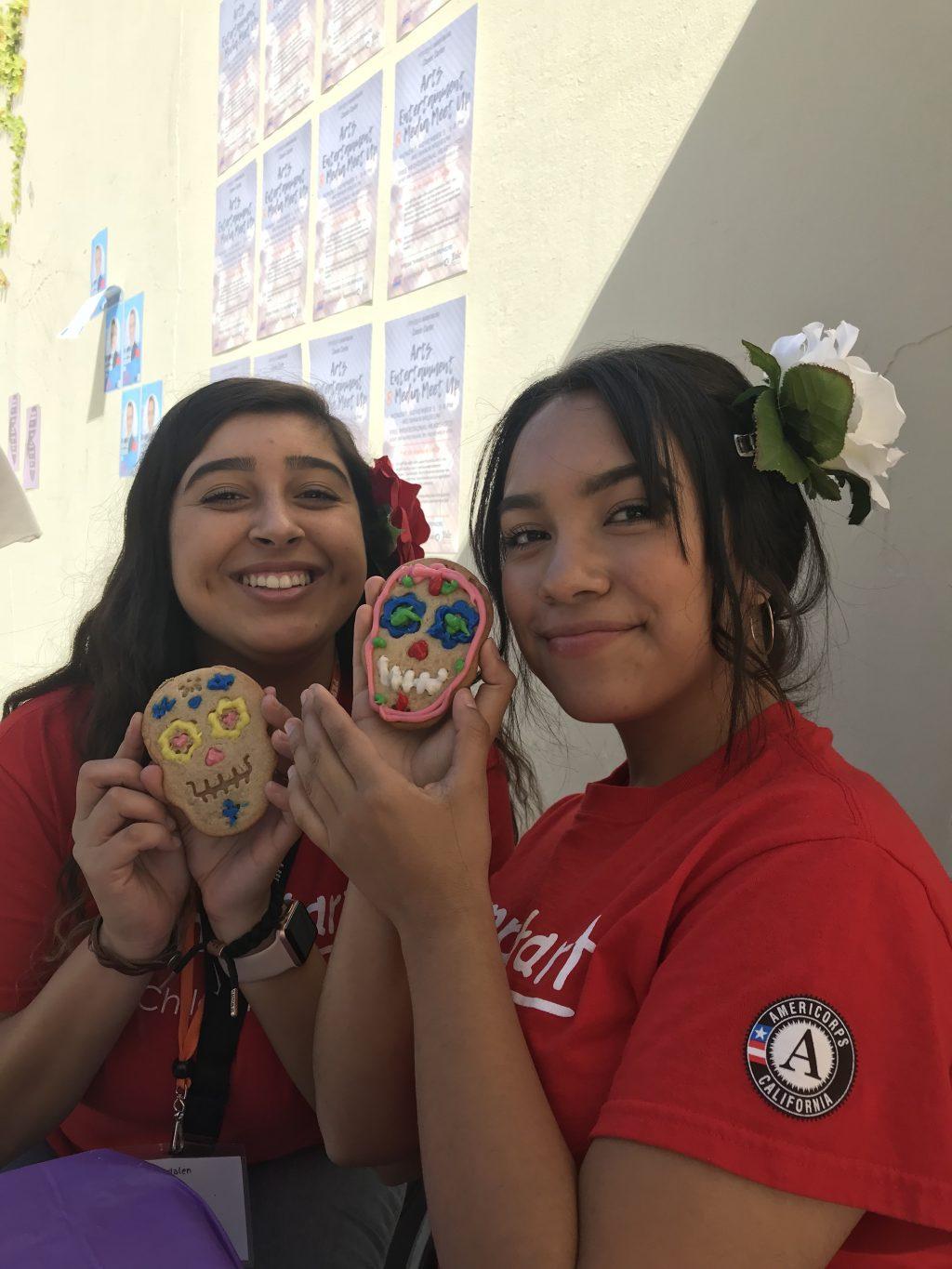 Celeste Benitez (right) decorates a colorful Día de los Muertos cookie with her friend and fellow LSA member Madalen Carrera on campus in November 2018. The pair tabled by the Rock on the Malibu Campus to promote the LSA's Noche de Altares (Night of the Alters) event. Photo courtesy of Celeste Benitez