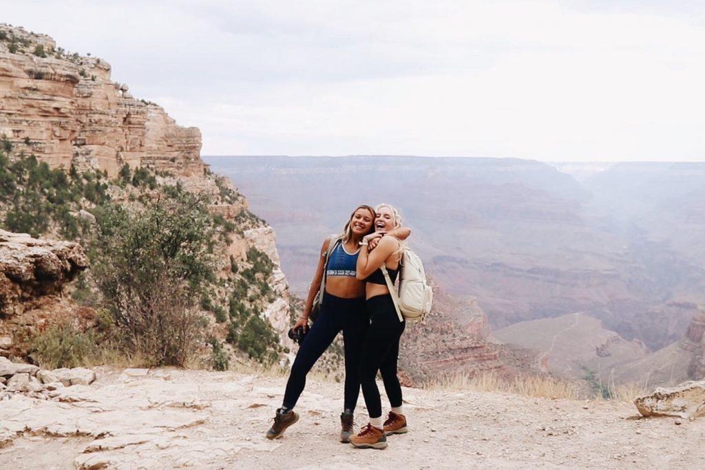 Wisniewski and Albach hug one another as they stand on top of a mountain in the Grand Canyon in Arizona in September. They traveled across the country through nine different states.