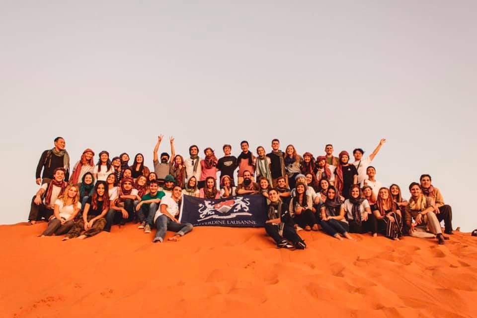 The fall 2019 Lausanne cohort cheers for a photo in the Sahara Desert. The Lausanne program was planning an annual trip to Morocco for the fall Educational Field Trip, but this year's trip, along with the fall 2020 program, was canceled due to COVID-19. Photo courtesy of Alicia Yu