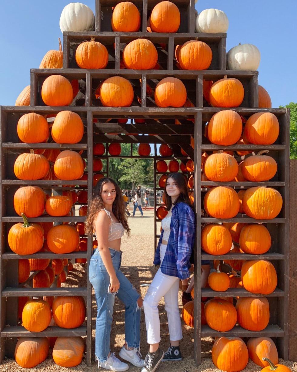 Samantha White (left) and her sorority sister chill under a pumpkin display at Underwood Family Farms in Moorpark, CA, this October. White said her favorite part about the holidays is the sense of community and unity it brings. Photo courtesy of Samantha White