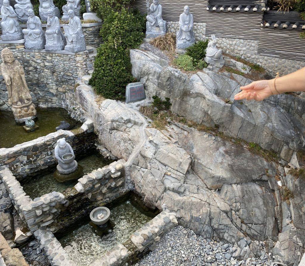 A woman throws a coin from a bridge into the Lucky Wishing Well at the Haedong Yonggung Temple on Oct. 3. Many families with children were at the temple, possibly because I visited the day following Chuseok's three-day holiday celebration.