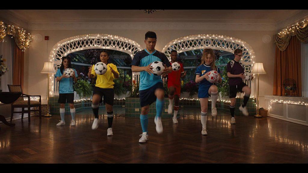 TBD members learn choreography for their soccer-styled dance show. Jake suggested incorporating hobbies, like soccer or taekwondo, into their final performance.