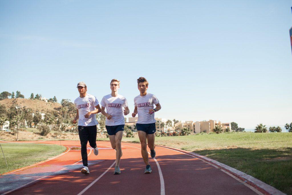 Freshmen Nate Lannen, Ryan Hemphill and Lerch do a quick shakeout run at the Stotsenberg Track on Oct. 27. The three runners live in the Lovernich Apartments on campus. Photo by Jaylene Ramli