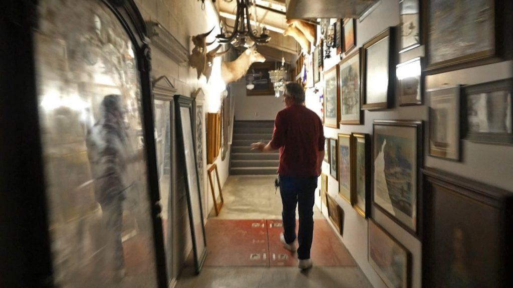 O’Rourke walks down the prop-laden hallway that provides access to Smother Theatre’s control booth March 2. In the early 2000s, students claimed to see a white image at the end of the hall.