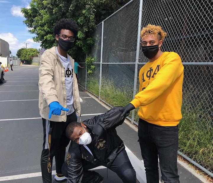 Senior Justus Bell, alumnus Matthew Paster and sophomore Kenzi Bishara of Alpha Phi Alpha pose for a photo during a food drive May 30. Bishara is the president of the fraternity. Photo courtesy of Kenzi Bishara