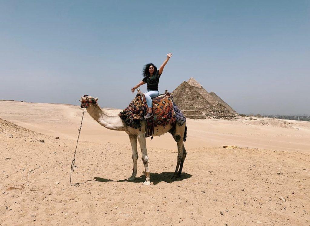 Tadros explores the pyramids in Cairo, Egypt, by camel in June 2019. Tadros' family is from Egypt, and Tadros visited the country for her first time last summer.