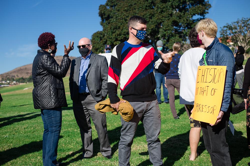 Faculty, students and administrators talk on Alumni Park. All in attendance wore masks and maintained social distance as much as possible. Photo by Ashley Mowreader