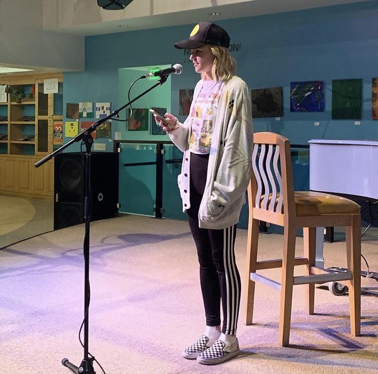 Senior Olivia Smith reads an original poem at the 2019 fall coffeehouse event. Cooper said sometimes students would come in for Jamba Juice and leave having read their original work. Photo courtesy of Amanda Cooper