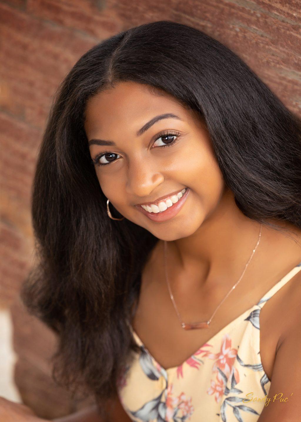 First-year Amani Pearson smiles for her senior portrait this spring in Columbine Hills Park in Littleton, Colo. This fall, she joined the Black Student Association and Alpha Omega Campus Ministry. Photo courtesy of Amani Pearson