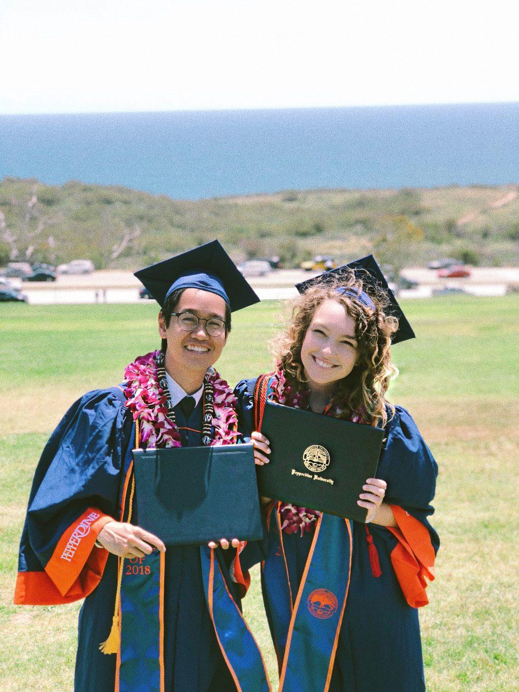Alumni Justin Lew and Elizabeth Hanley hold their diplomas in front of the Pacific Ocean after graduating from Pepperdine in April 2018. The pair originally started out as friends, but now they have been dating for three years. Photo courtesy of Elizabeth Hanley