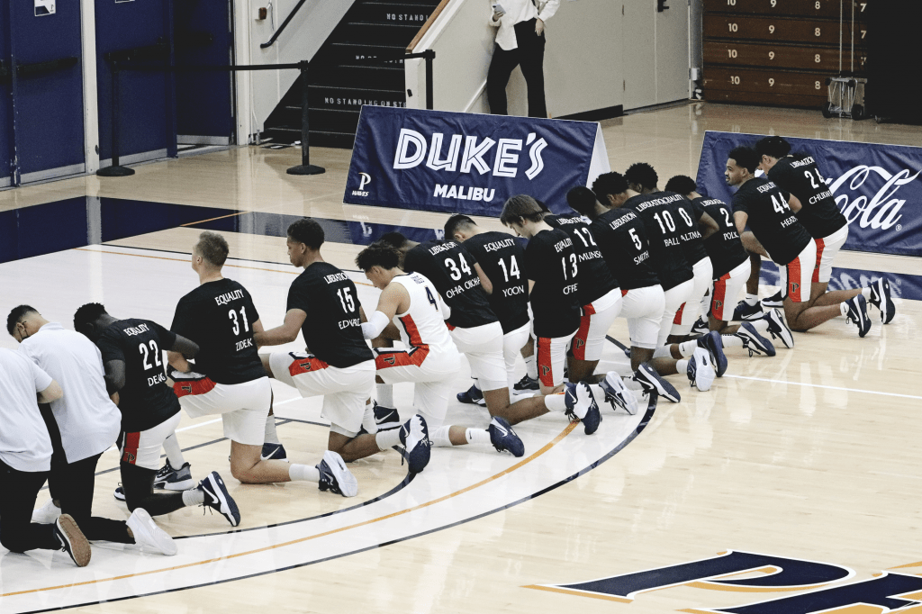 All 14 men's basketball players kneel for the national anthem before defeating Pacific University on Jan. 21 game at Firestone Fieldhouse.