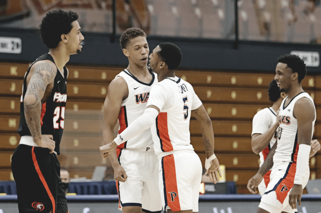 Smith (No. 5) congratulates Edwards after the latter reached 1,000 points and a game-high scoring record of 37 points. ***reword with the correct terminology, I tried my best lol