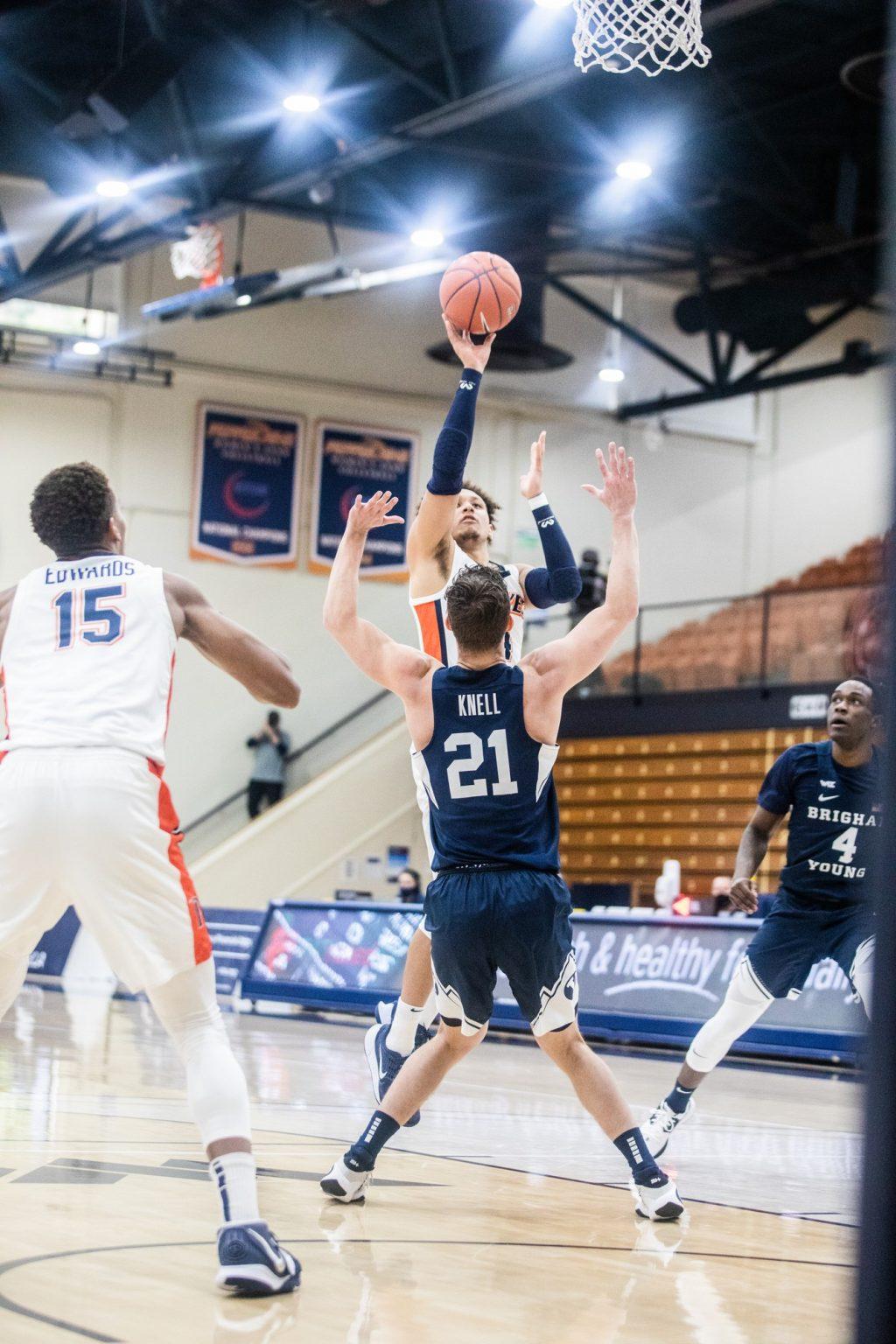 Ross shoots a right-handed floater in the paint as BYU sophomore guard Trevin Knell (No. 21) attempts to take a charge. Ross finished 4-17 from the field but shot 11-13 from the free-throw line.