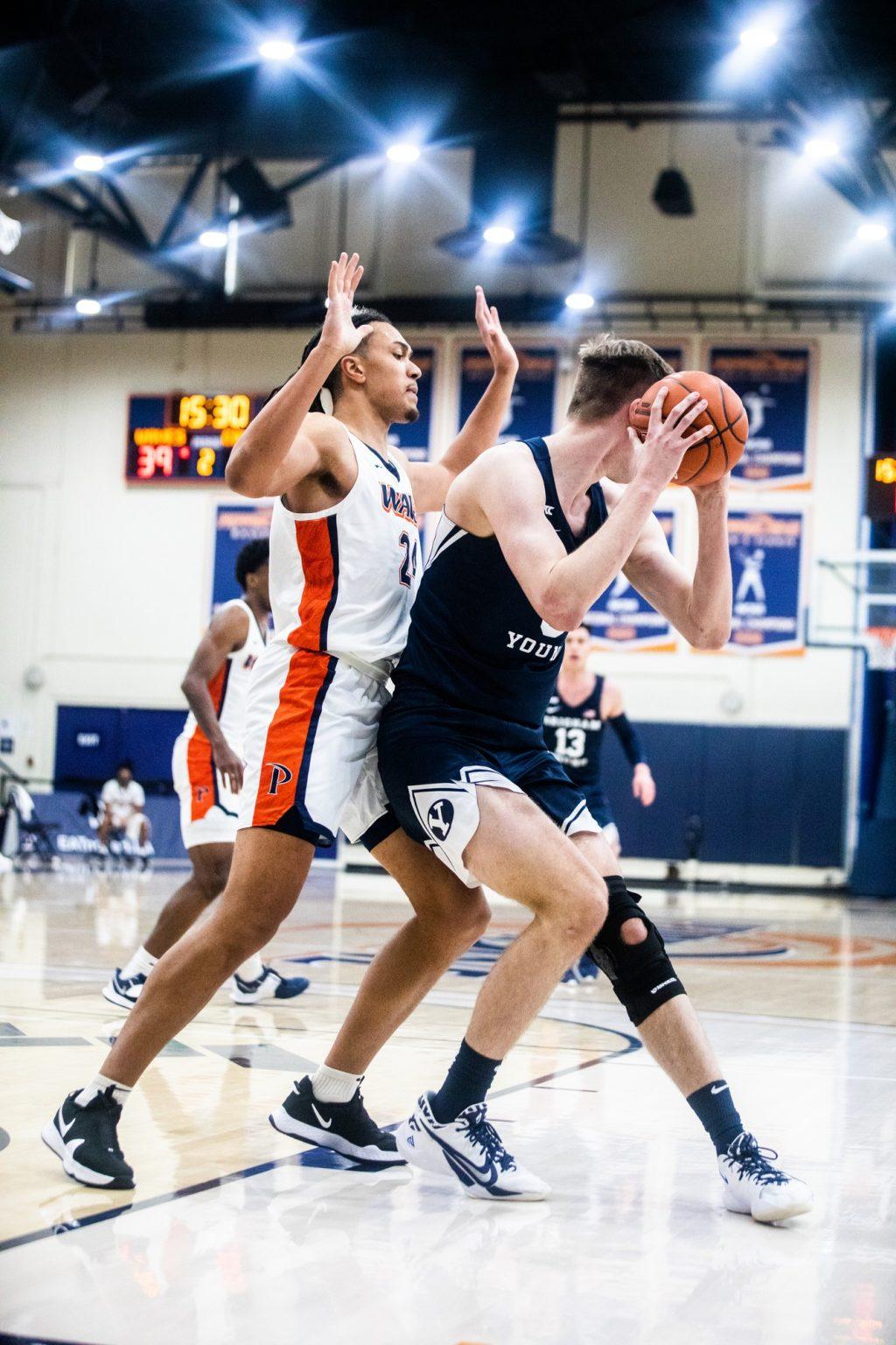 Fifth-year forward Kene Chukwuka plays defense against Haarms on the right block. Chukwuka got into foul trouble early in the game and finished with three points and two rebounds.