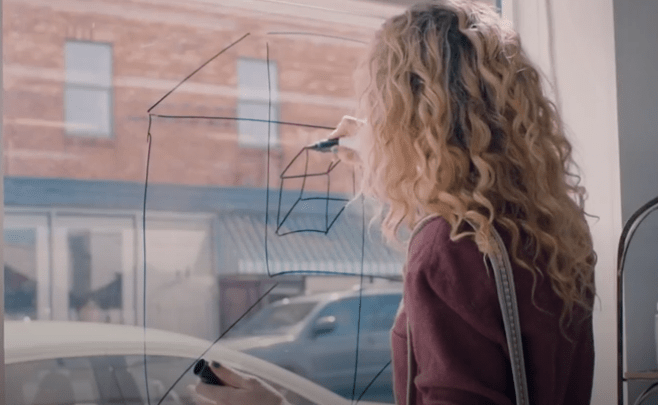 Margaret draws cubes on a window of a bookstore. She explained the mystery behind the cube to Mark and how they can get in and out of the time loop.