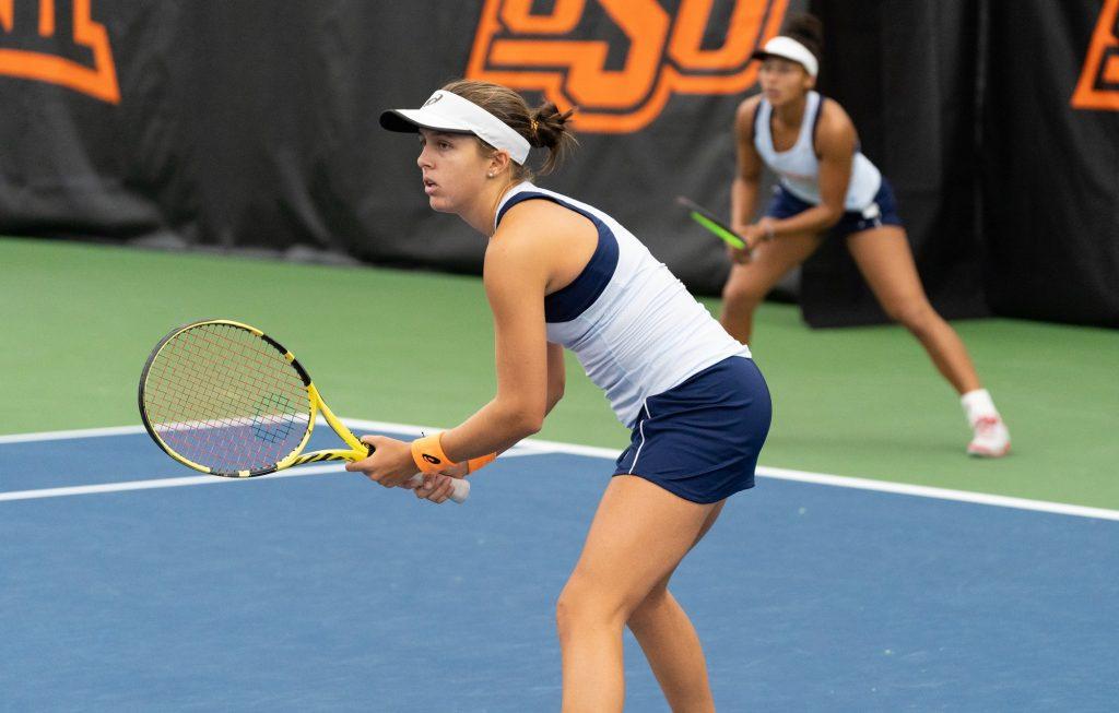 Freshman Nikki Redelijk (foreground) and sophomore Astrid Olsen (background) await a serve from a North Carolina doubles team Feb. 6 in Stillwater, Okla. Olsen and Redelijk lost the doubles match and the Waves lost the semifinal match against the Tar Heels 4-1.