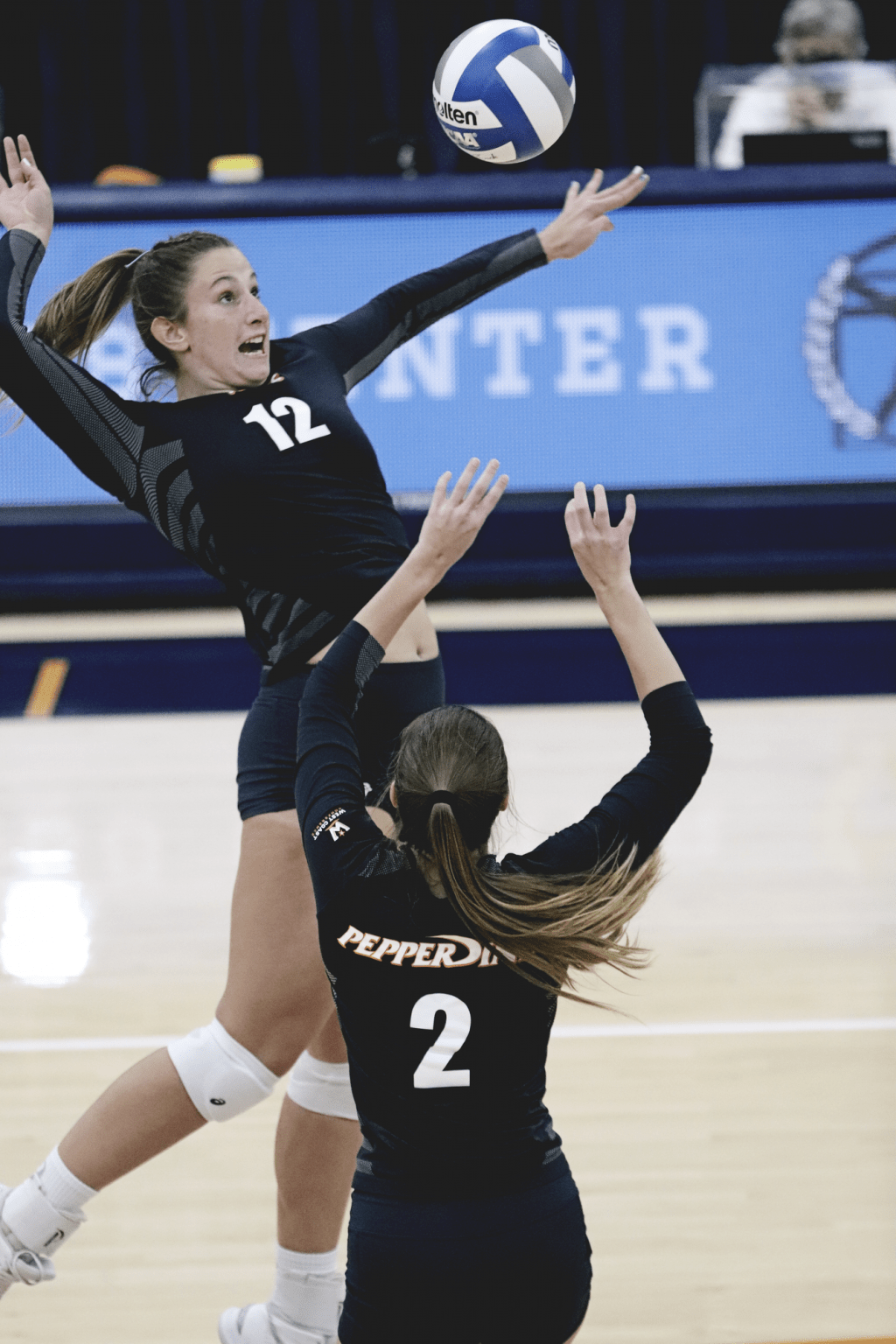 Freshman middle blocker Meg Brown aims and arches for a quick-set from sophomore setter Isabel Zelaya.