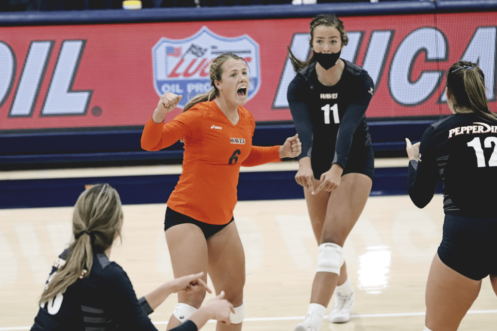 Junior libero Madison Shields (No. 6) celebrates after a second-set point with teammates Ahrens, Ammerman and Brown.