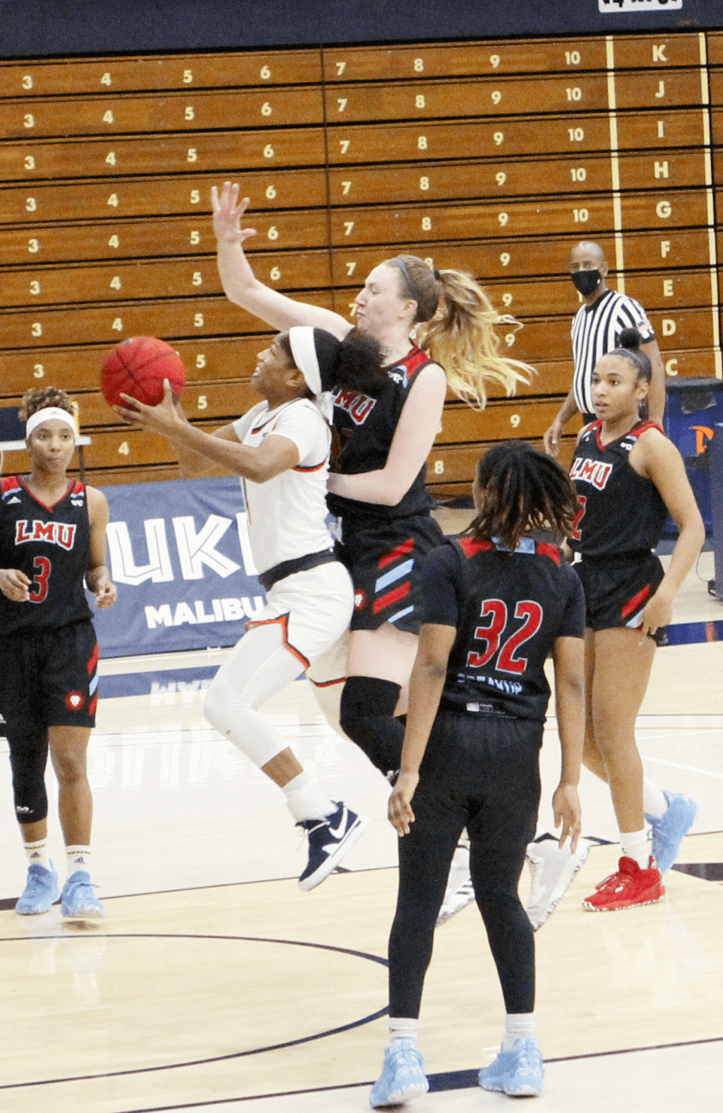 Junior guard Cheyenne Givens drives the lane against LMU's Megan Mandel during Saturday's win. The Waves survived a second half Lions comeback to notch their first WCC win of the season.