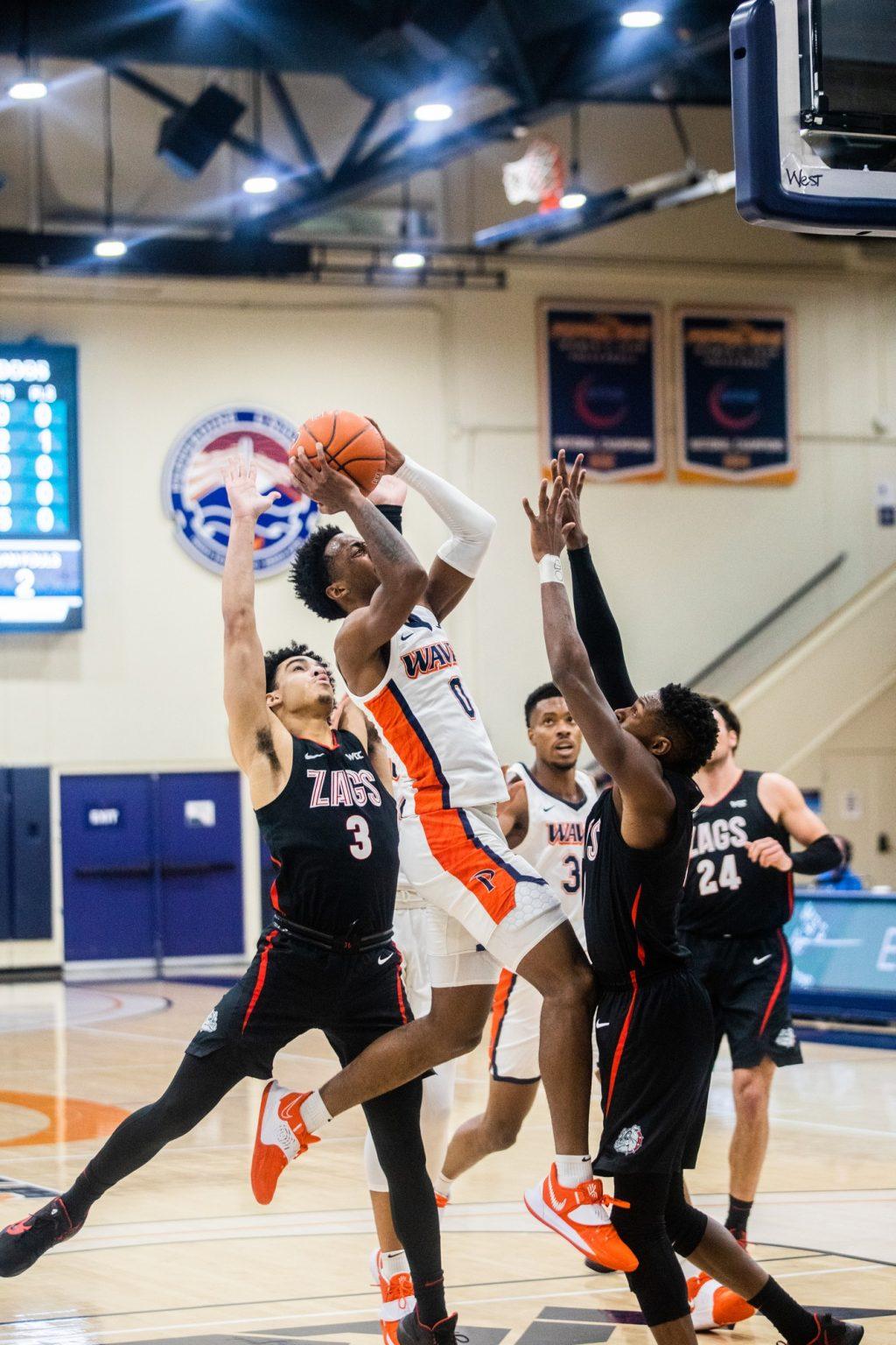 Sophomore guard Sedrick Altman rises up for a shot between Gonzaga's Joel Ayayi (right) and Andrew Nembhard (No. 3) in the first half of Saturday's game at Firestone Fieldhouse. Altman scored 14 points in the game and also collected 6 rebounds, 4 assists and 3 steals.