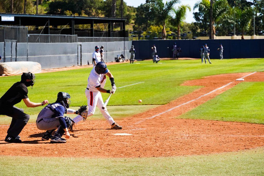 Senior catcher Joe Caparis swings low in game two against CBU. Caparis had a .164 batting average last season and has yet to secure his first hit.