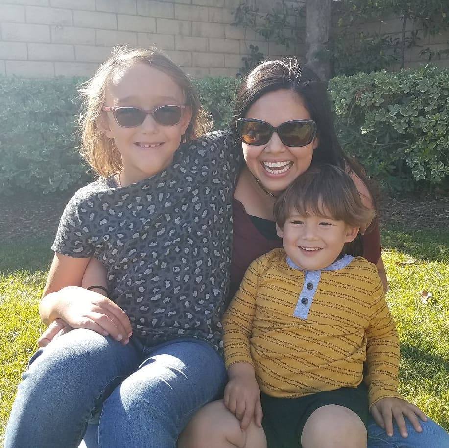 Martínez and her two children smile at a park in November in Camarillo, Calif. Martínez said when she was hired by Pepperdine she had just given birth to her son, and she brought him to all her trainings.