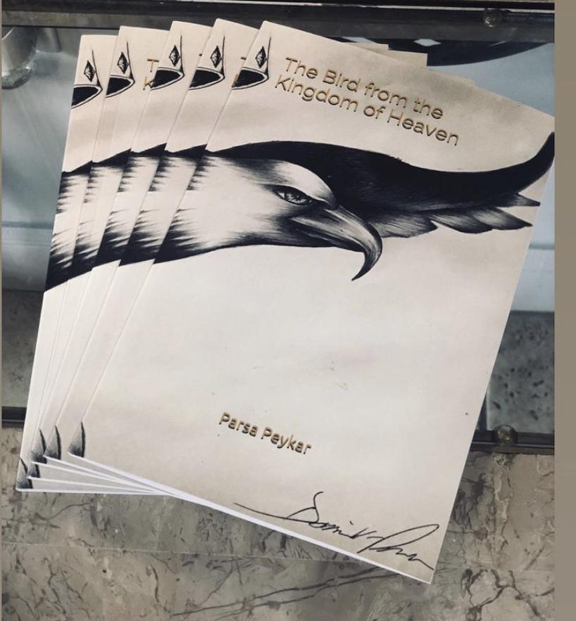 English copies of "The Bird From the Kingdom of Heaven," splay across a table in October 2018. Peykar said the book is about a caged bird that finds freedom.