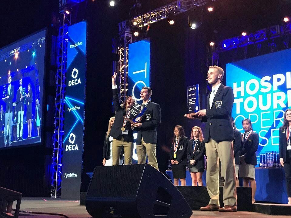 Chaffin (left) and her partner accept their second-place trophy at the International Career Development Conference (ICDC) in Atlanta in 2018. The founder competed nationally and internationally in DECA in high school. Photo courtesy of Heather Chaffin