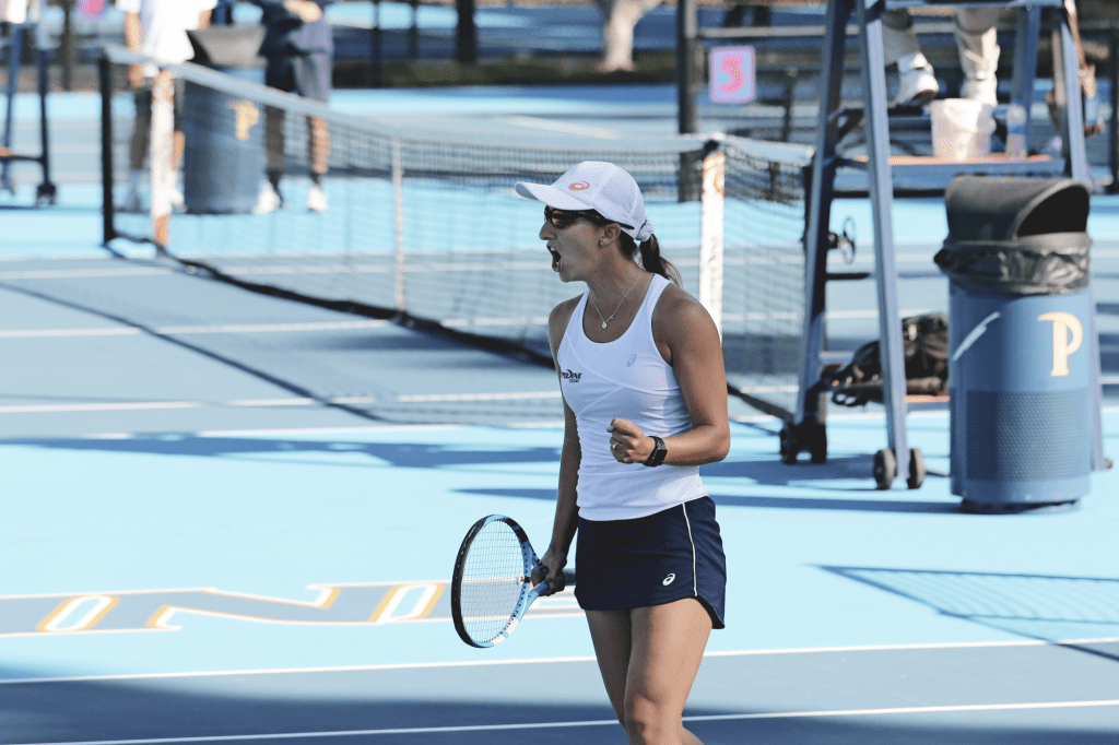 Sixth-year senior Jessica Failla celebrates a point during her singles match against Alana Wolfberg of Oklahoma State on court one. Failla's match went unfinished but the Waves swept the Cowgirls 4-0.