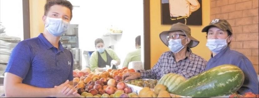 Djalilov poses next to the produce at the farmer's market inside Magaly's Tamales & Mexican Grill in October in San Fernando, Calif. Djalilov said Magaly's Tamales is owned by the family of Pepperdine junior Karina Ortega, and is one of the restaurants that holds charitable events for the community.