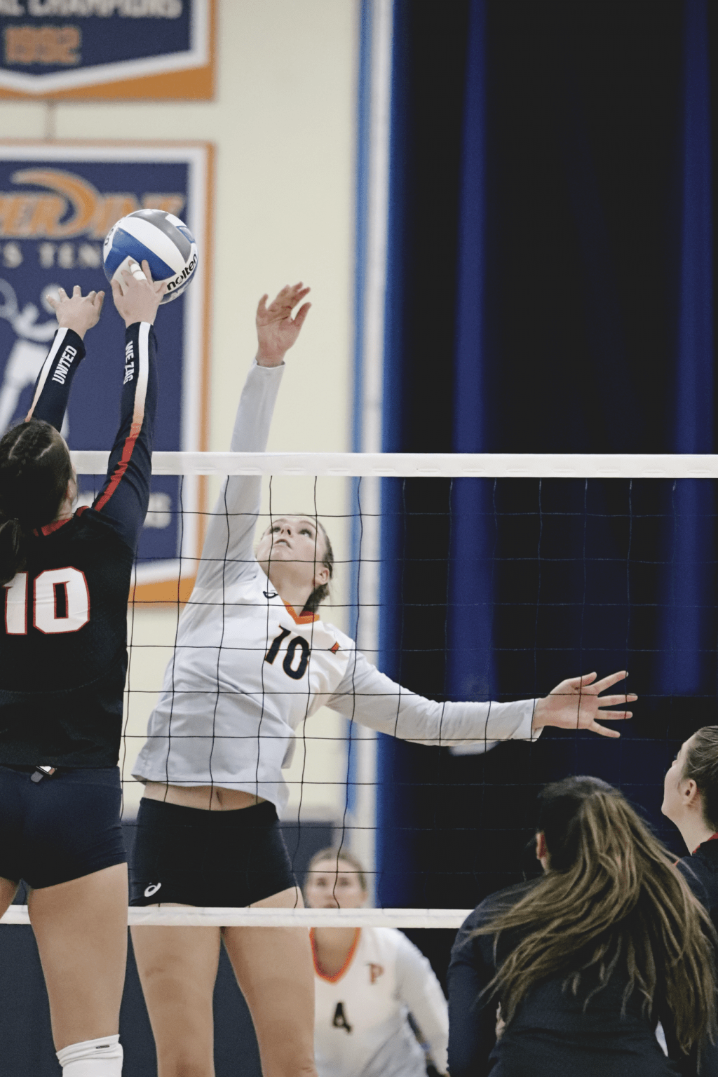 Senior outside hitter Shannon Scully (in white) rises for a tip against Gonzaga redshirt senior Katelyn Oppio during Friday's match. Scully led all hitters with 15 kills and a .469 hitting percentage in the match.