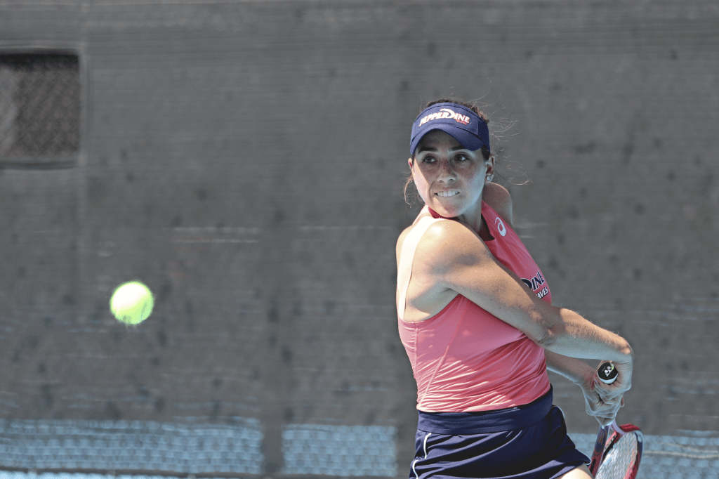 Redshirt Freshman Lexi Ryngler winds up for a hit in her doubles match March 25. Ryngler and partner Olsen won their doubles match 6-2.