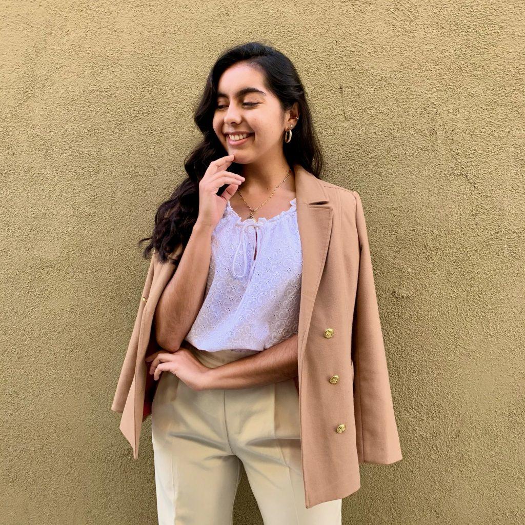 Chavez models hand-picked pieces in Long Beach, Calif., in January to sell on her second-hand Instagram shop, @thrift.w.maria. Chavez created this shop to celebrate and promote sustainable fashion. Photo courtesy of Maria Chavez