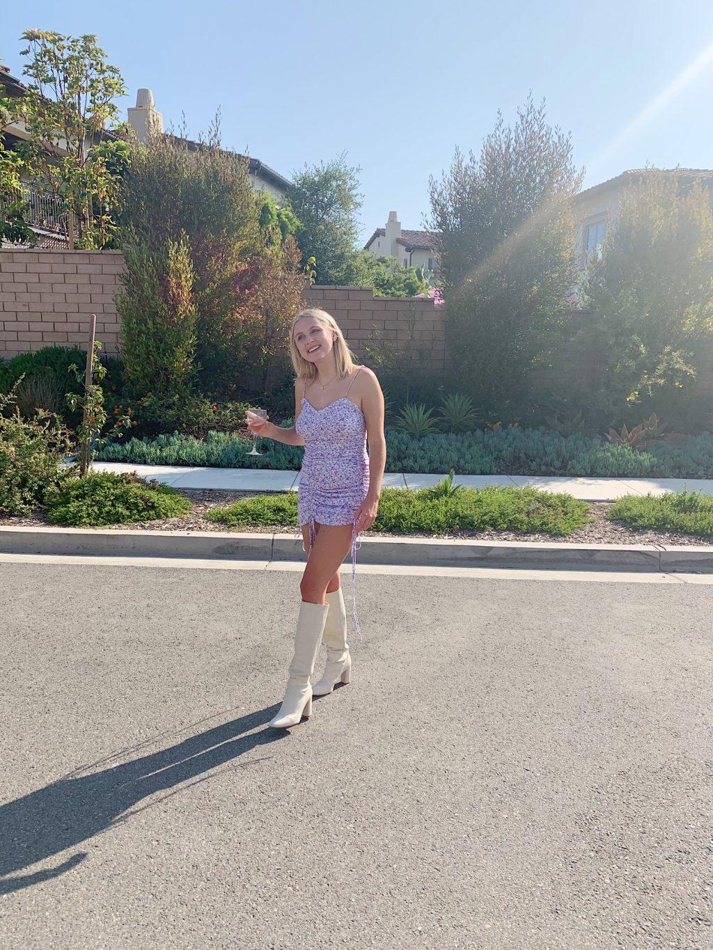 Senior Taylor Launius poses in a floral dress and knee-high white boots at a friend's birthday in San Clemente, Calif., in July. Launius said she loves wearing bright colors during the spring. Photo courtesy of Taylor Launius
