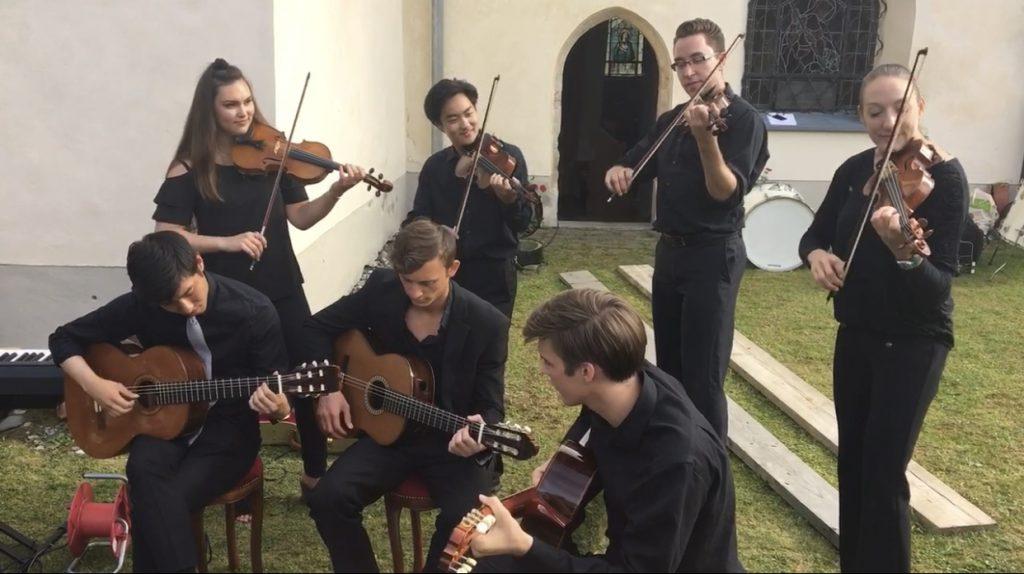 Senior violinist Alexa Birt (second row, far left) and fellow musicians play at St. Stephen's Cathedral in Austria in July 2017, during her summer in the Heidelberg Summer Music Program. The students gave an impromptu outdoor performance of Celtic music after their chamber concert inside the church. Photo courtesy of Alexa Birt
