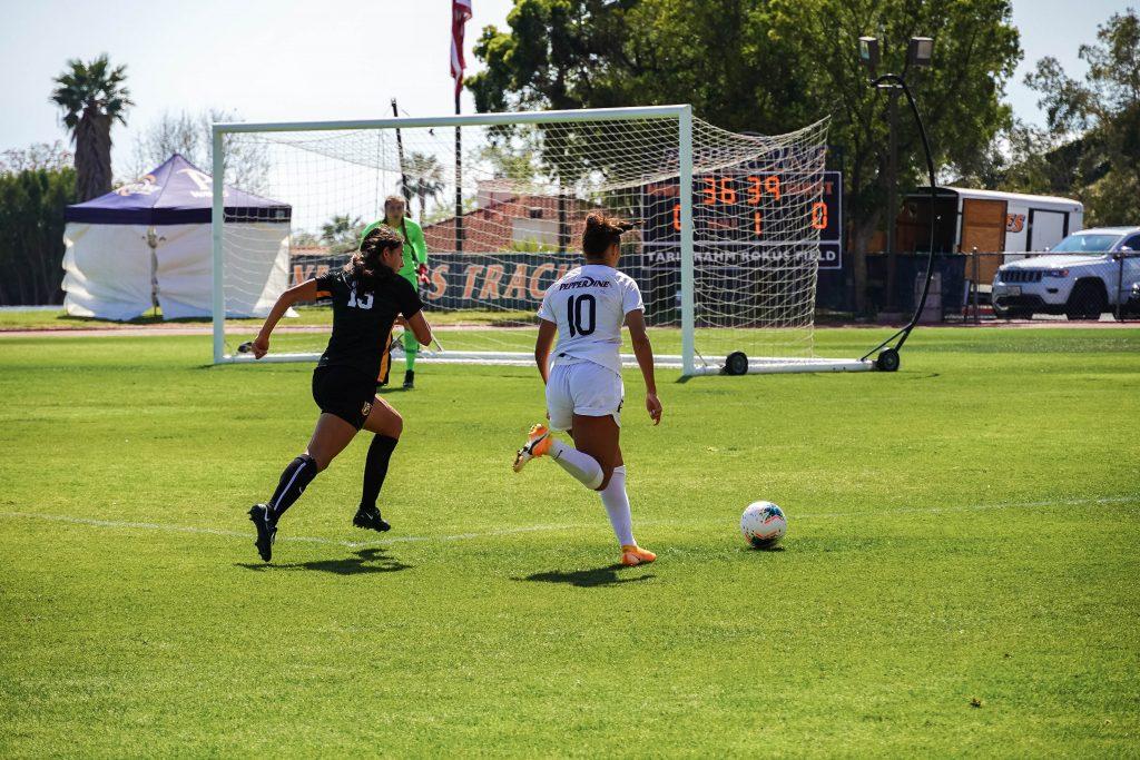 Senior forward Calista Reyes (No. 10) makes a run down the right hand side of the pitch against San Francisco. The Waves attempted to play over the top early in the match, but found more success sending through balls on the ground.