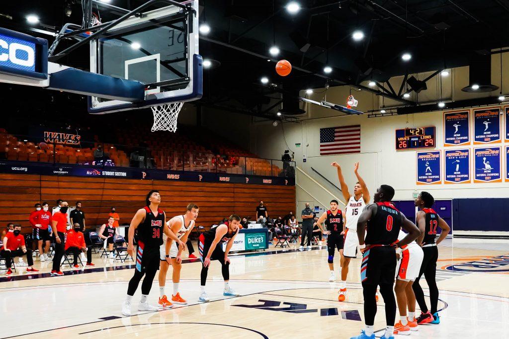 Junior Kessler Edwards shoots a free throw while down three points against LMU. Edwards put up a hard-fought 14 points, 6 rebounds and 2 blocks in the loss.