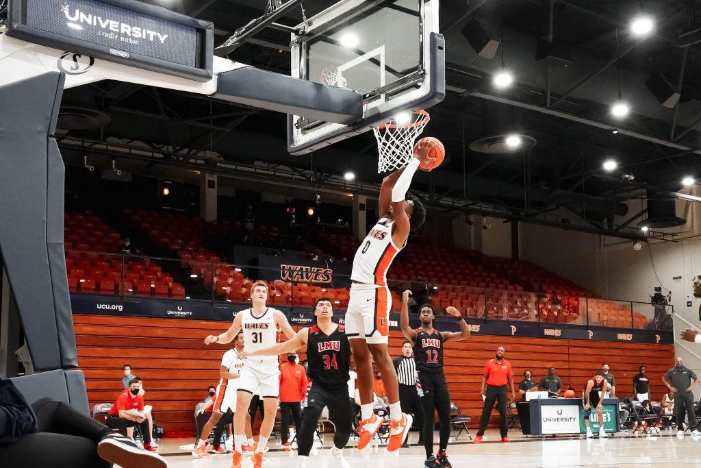 Sophomore guard Sedrick Altman converts a transition layup in the first half versus LMU. Altman contributed to the Waves' 74 points with 10 points, 3 rebounds and 2 assists.