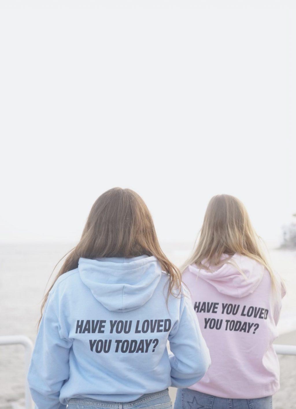 Sophomores Blakely Huff (left) and Clare Cornelius (right) promote Gearhart&squot;s new company in her "Have you loved today?" sweatshirts in September at Ralphs Beach in Malibu. Gearhart said her main mission is to spread self-love and positivity with her company.
